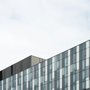 Contemporary glass office building exterior showcasing geometric patterns and modern architecture.